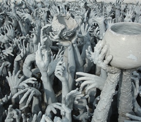 Outstretched arms at entrance to White Temple