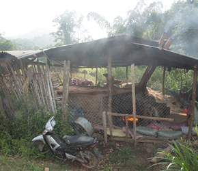 Grain drying, man and rake atop, fire below