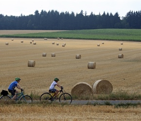 Daniel and Harrison pass straw bales near Assesse