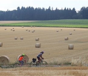 Hannah and  Hannah pass straw bales near Assesse