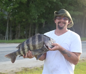 Fisherman with his catch at our accommodation at Core Creek