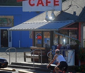 Carel enters the Otis Cafe. These signs are so American