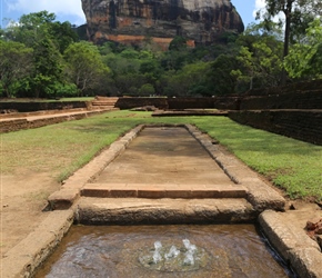 You can make out the water coming out from the fountains which consist of  circular perforated limestone slabs. (photo at lower left) The fountains are fed by underground water conduits and operate on a gravity feed system