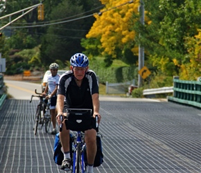 Malc crosses the bridge to New Castle. These metalled bridges can be very slippery in the wet. With a tandem, John wisely walks it