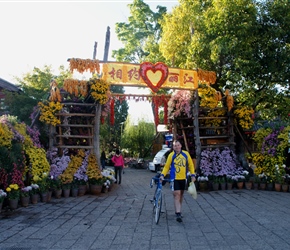 Graham leaves Lijang through the flowering arch