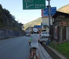 Gina takes a picture of the Shangri La Sign at Tiger Leaping Gorge