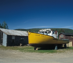 Boat in a front yard.