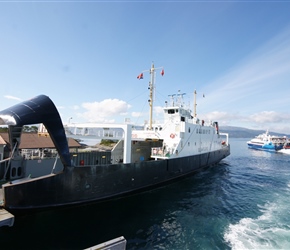 Express ferry departs leaving the local ferry to load