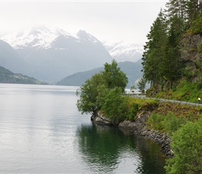 John riding along the edge of Innvikfjorden