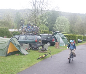 Oliver cycling through the campsite