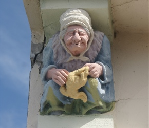 Gargoyle under the eaves in a house as we cycled into Pirou Plage