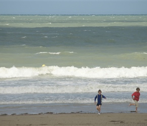 James and Edward in the surf at Pirou Plage