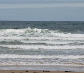 Louise and Lucy try the temperature at Bamburgh Beach