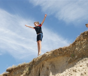 Katie leaping the dunes