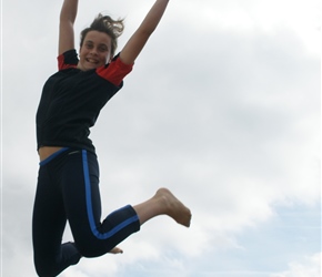 Katie leaping the dunes