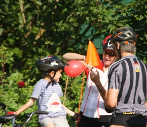 It was Gary's birthday, so Karen tied balloons to his tandem