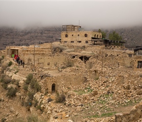 Tour of Dana. At about 500 years of age, many houses were built simply with rocks and clay. Almost all have fallen, with arches and a few walls remaining. Gradually though coming back to life