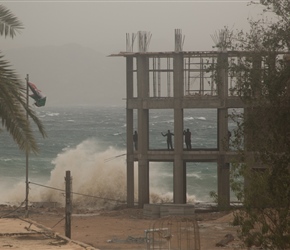 As the storm raged, people were doing all sorts of things for a selfie. These guys climbed a half finished building near the surf