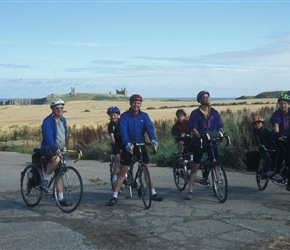 Malcom, John, Geoff and Nicola with Dunstanburgh Castle begind