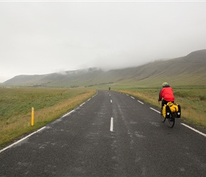 Mike heads along a wide U shaped valley, full of farms