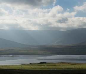 Round bales glint in the sun as we approach the road along Kjósarskarðsvegur