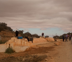 Drawing water from the well with donkeys and containers