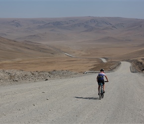 Lorna descends the downhill section on the unmade section through the cutting