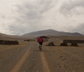 Claire passes through a farmstead, complete with piles of dried manure to burn for fuel