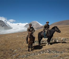 The borer guards in front of Khüiten Peak and glacier. They were conscripts in their second year. This is close to the border, note their guns 