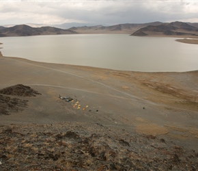 Sharon an Neil climbed the hill behind the campsites. The view of the site and lake were impressive. Hay was being harvested to the right using large Russian trucks to carry it away