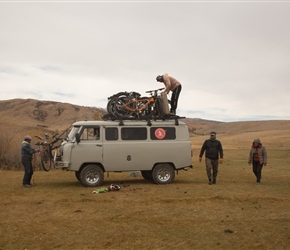 Tuul loas the bikes on the van for transporting. How they squeezed 10 days food, camping gear, bikes and us into these 3 vans is a miracle