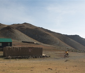 Peter halfway up the climb, passes a winter farmstead