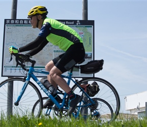 Issy, one of our guides, passes Keinawa Cycling Road sign