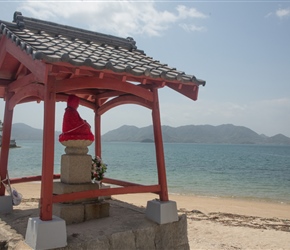 A Buddha overlooks the sea