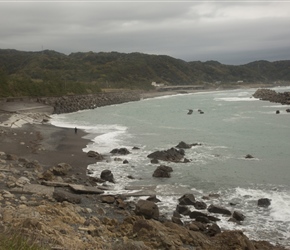 A fisherman tries his luck in the surf of the west coast