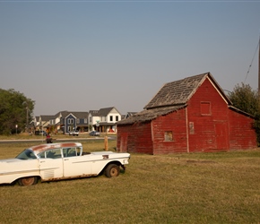 Old car and red building