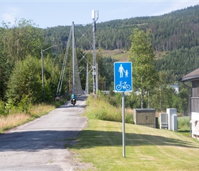 Sharon crossing a cyclists suspension bridge at Rollag