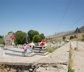 Julie cycles past graveyard